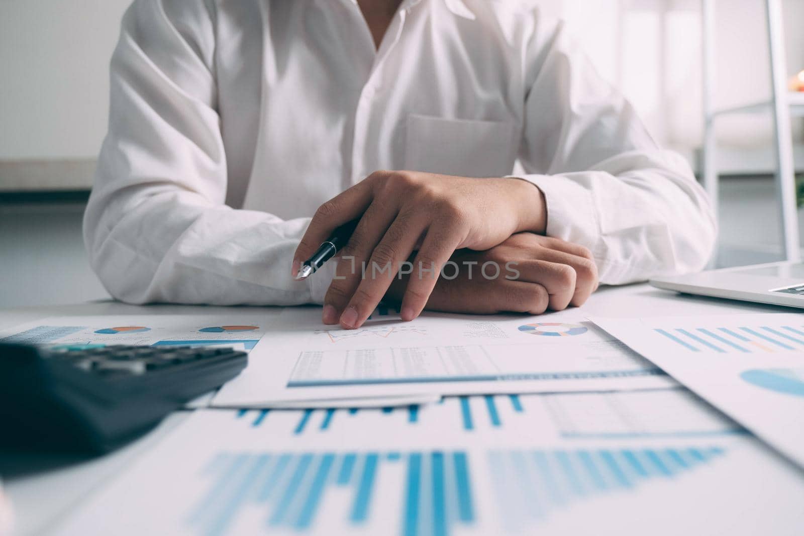 Businessman working financial Manager Researching Process accounting calculate analyse market graph data stock information review on the table in office.