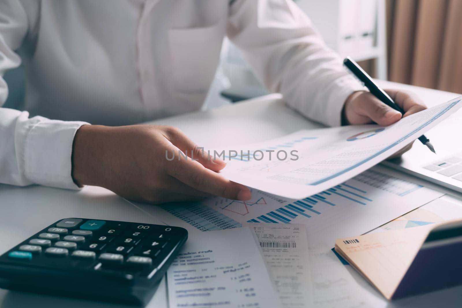 Businessman working financial Manager Researching Process accounting calculate analyse market graph data stock information review on the table in office.