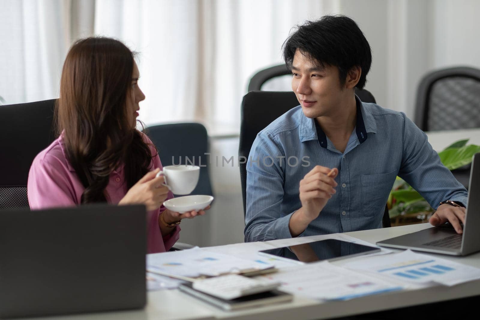 Asian business adviser meeting to analyze and discuss the situation on the financial report in the meeting room.Investment Consultant,Financial Consultant,Financial advisor and accounting concept.