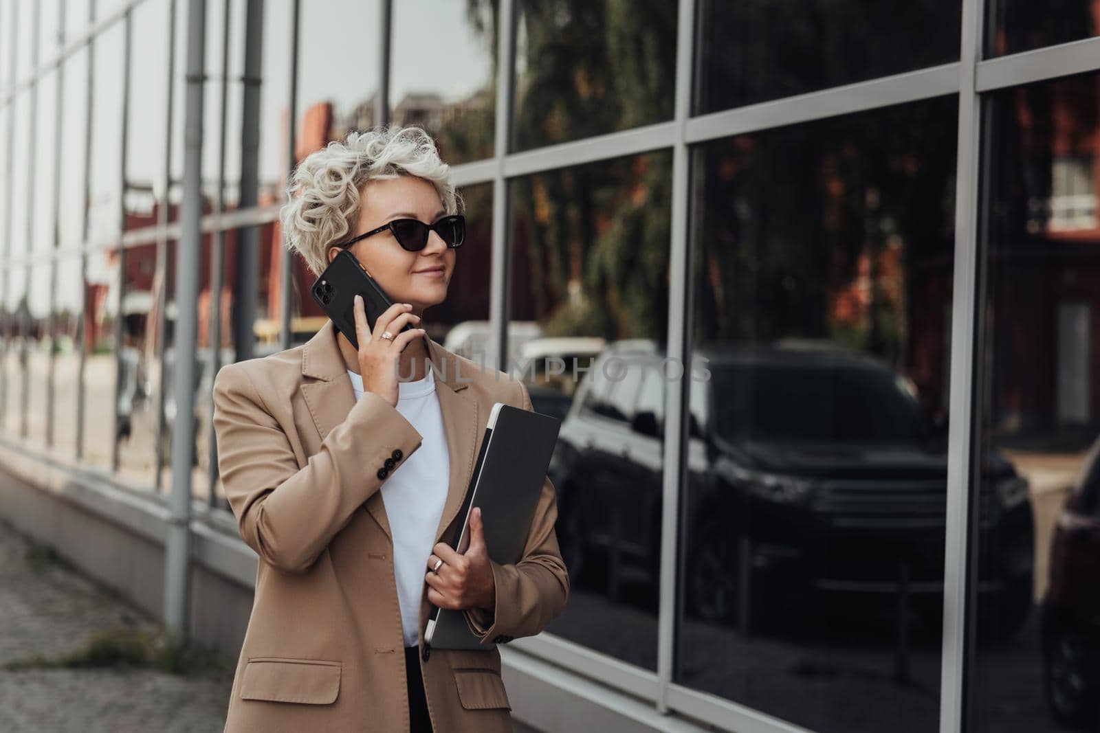 Modern Business Lady Smile and Talking on Phone When Holding Laptop Outdoors