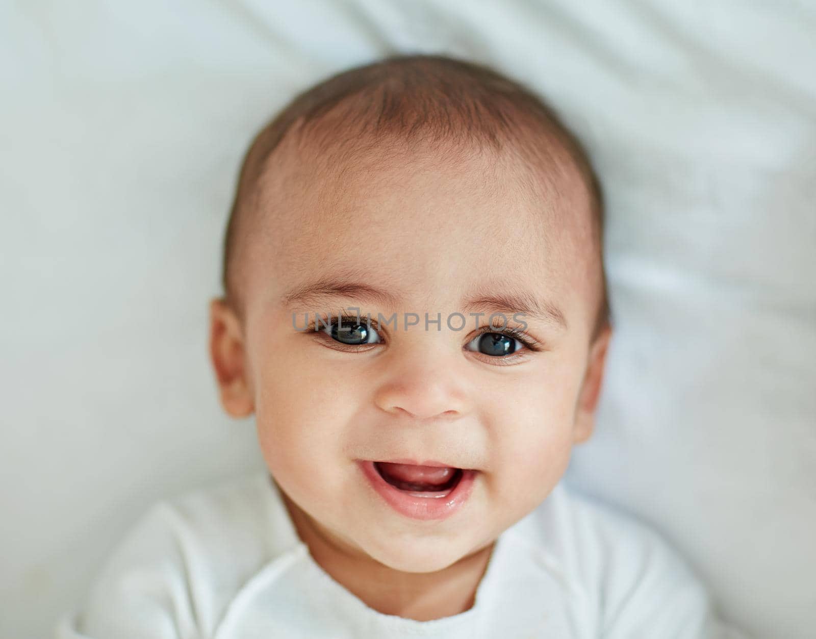 Cute doesnt get any cuter than this. Shot of an adorable baby boy at home. by YuriArcurs
