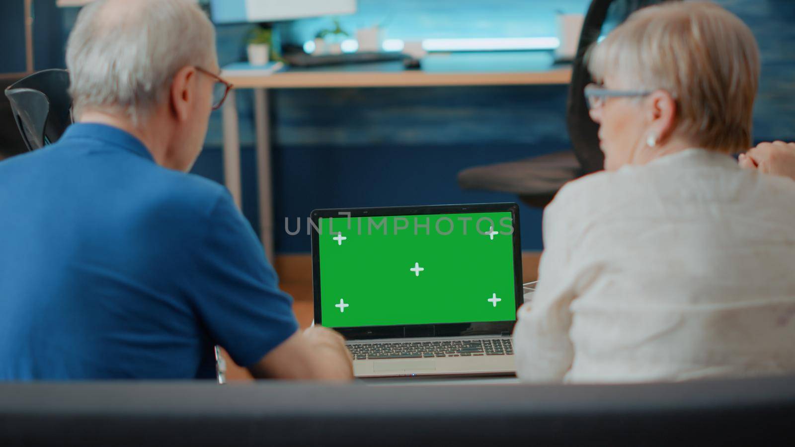 Old people with disability analyzing laptop with green screen by DCStudio