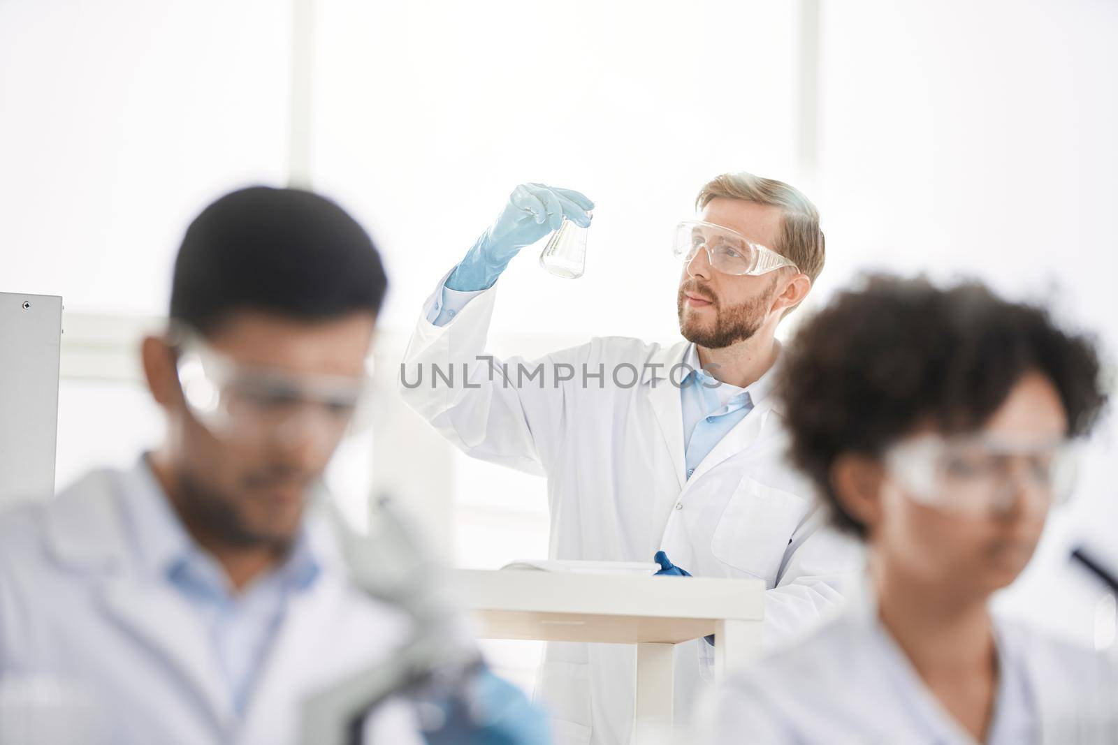 image a group of scientists working in a laboratory. by SmartPhotoLab