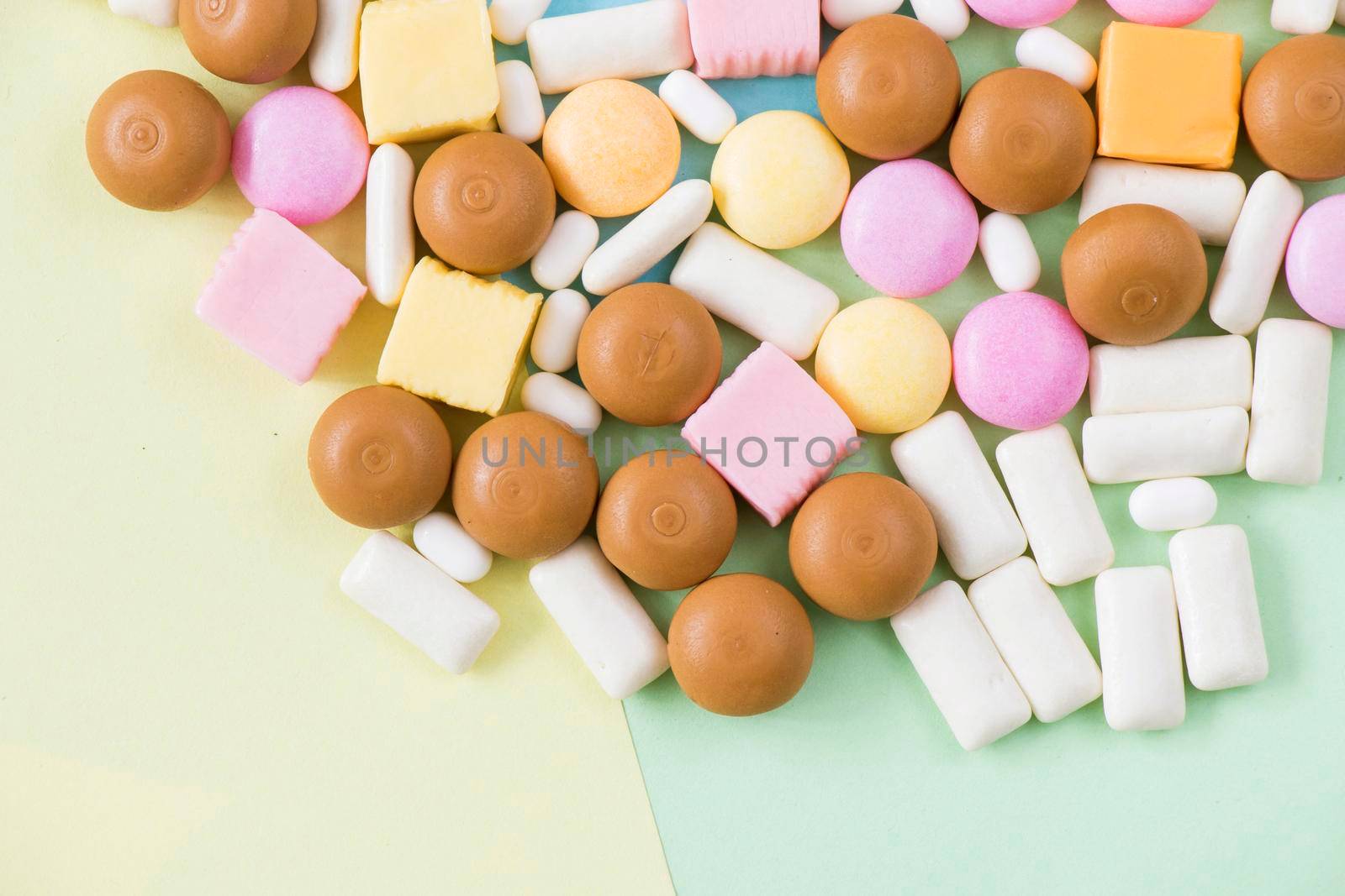 Sweet colorful confectionery, candy on the color background by Taidundua