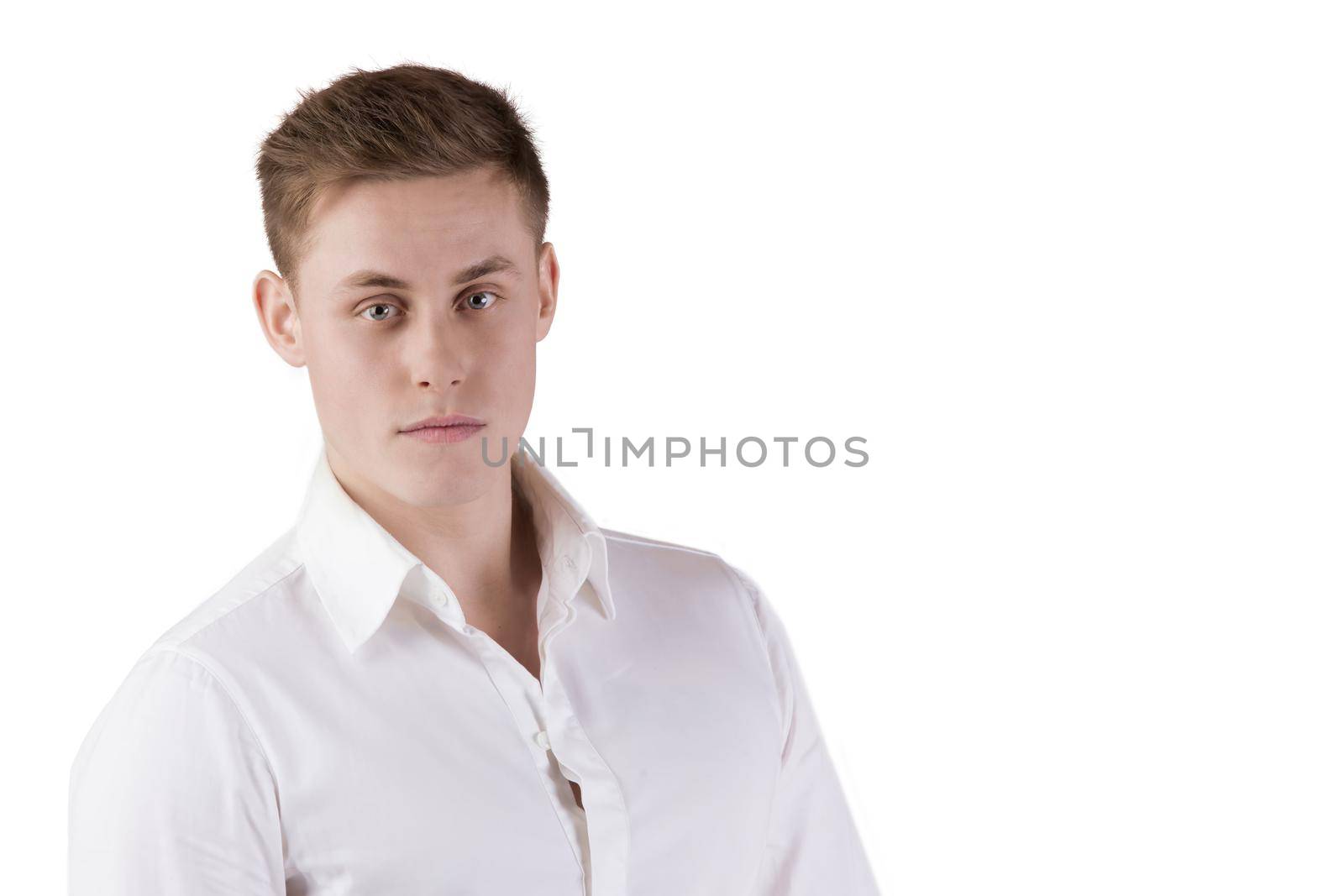 Portrait of a young man in a white shirt on an isolated background.