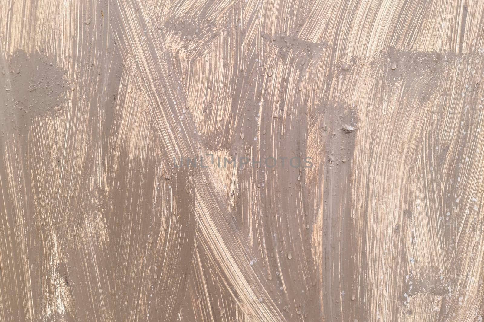 The surface of the iron is casually painted with beige paint. Grunge background.