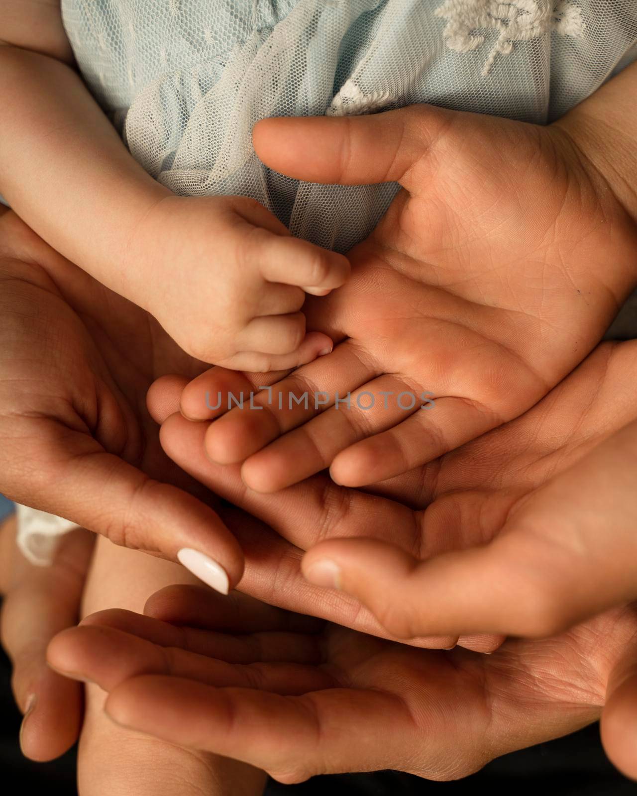 Close up of loving mom dad and kid hold hands on floor palms up together express closeness and unity, caring parents join stack arms with child show devotion, support and bonding. Family value concept