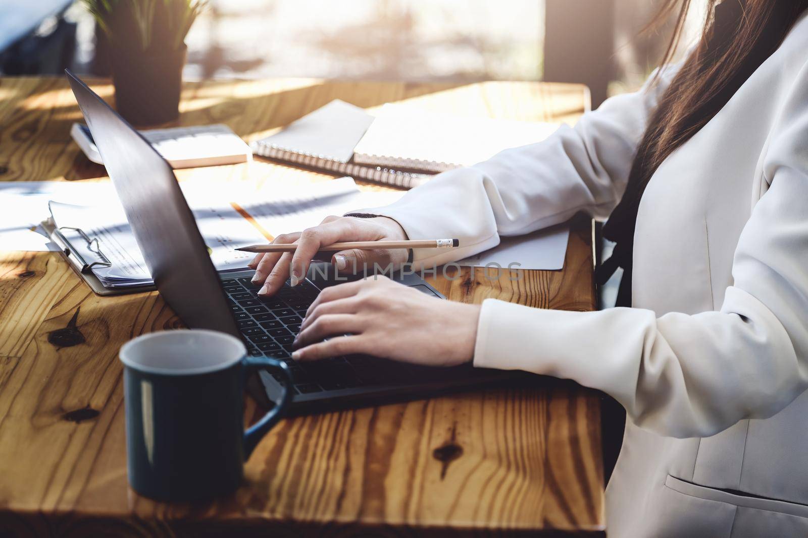 Young economists or accountants or financiers and investors are reviewing budget documents and using computers to study impact and risk assessments on corporate investment management