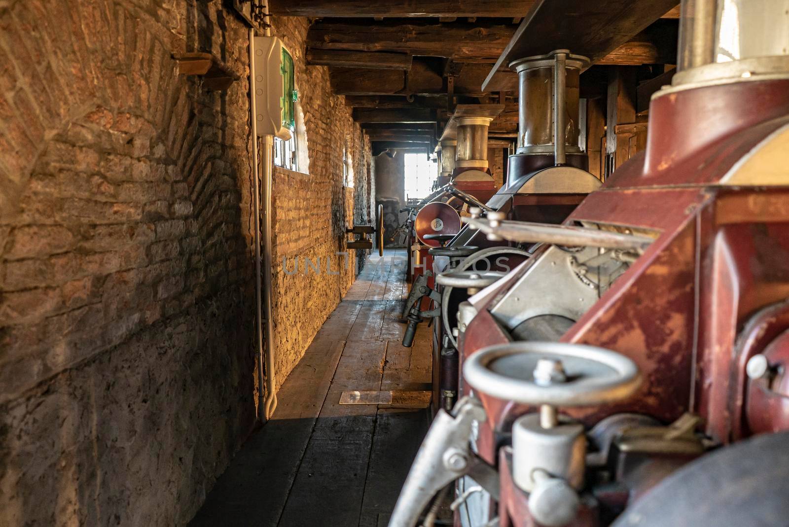 Interior of an old historic factory with machinery by pippocarlot