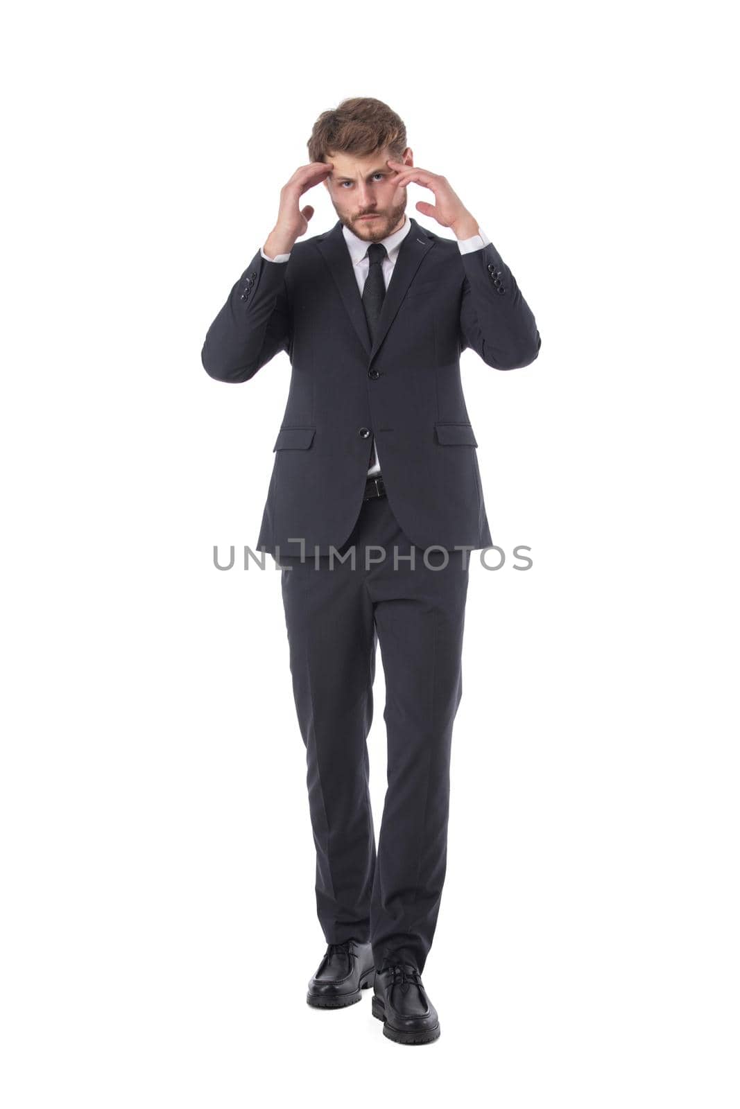 Businessman having a headache full length studio portrait isolated on white background