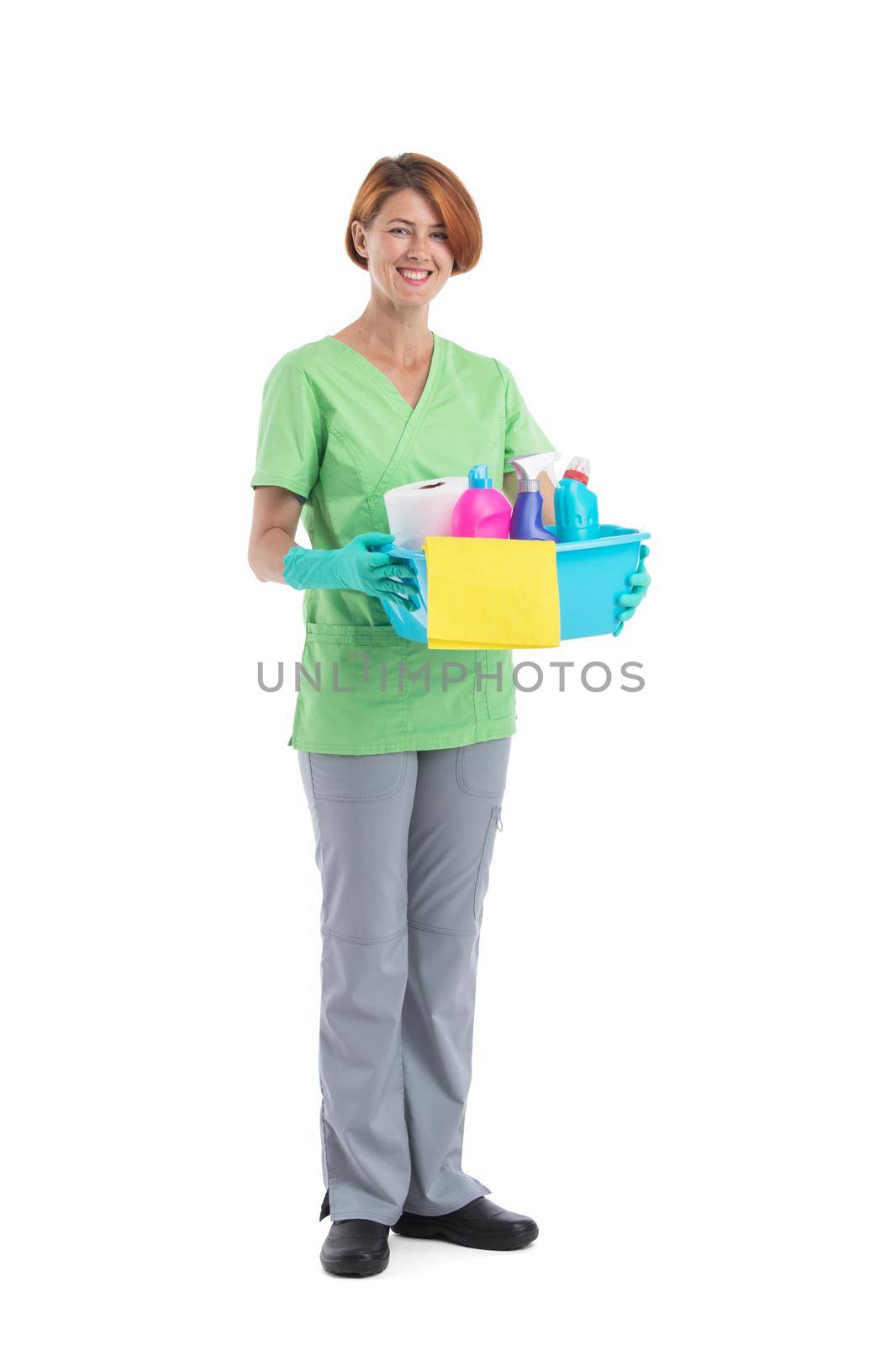 Full length portrait of professional cleaner woman holding box with cleaning supplies isolated on white background