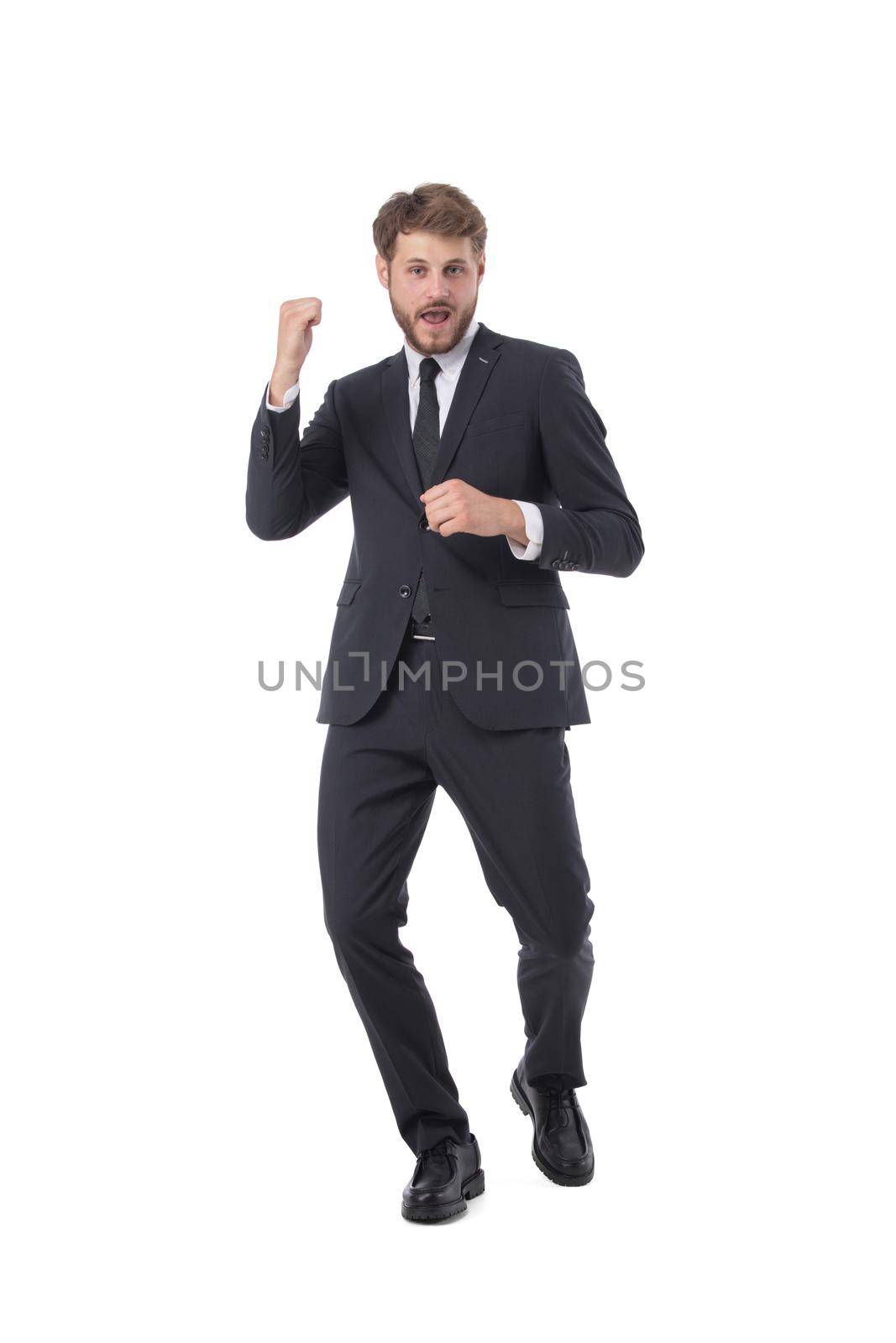 Cheering successful business man holding fists full length studio portrait isolated on white background