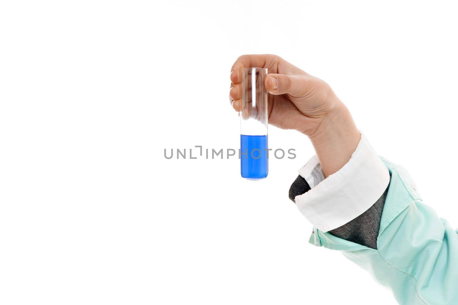 Female doctor holding test tube with blue liquid on white background.