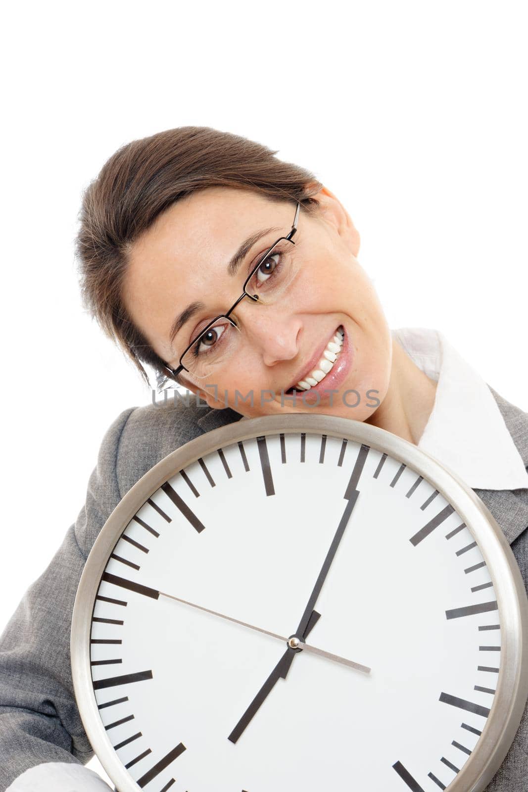 Young business woman smiling holding a clock on white background.