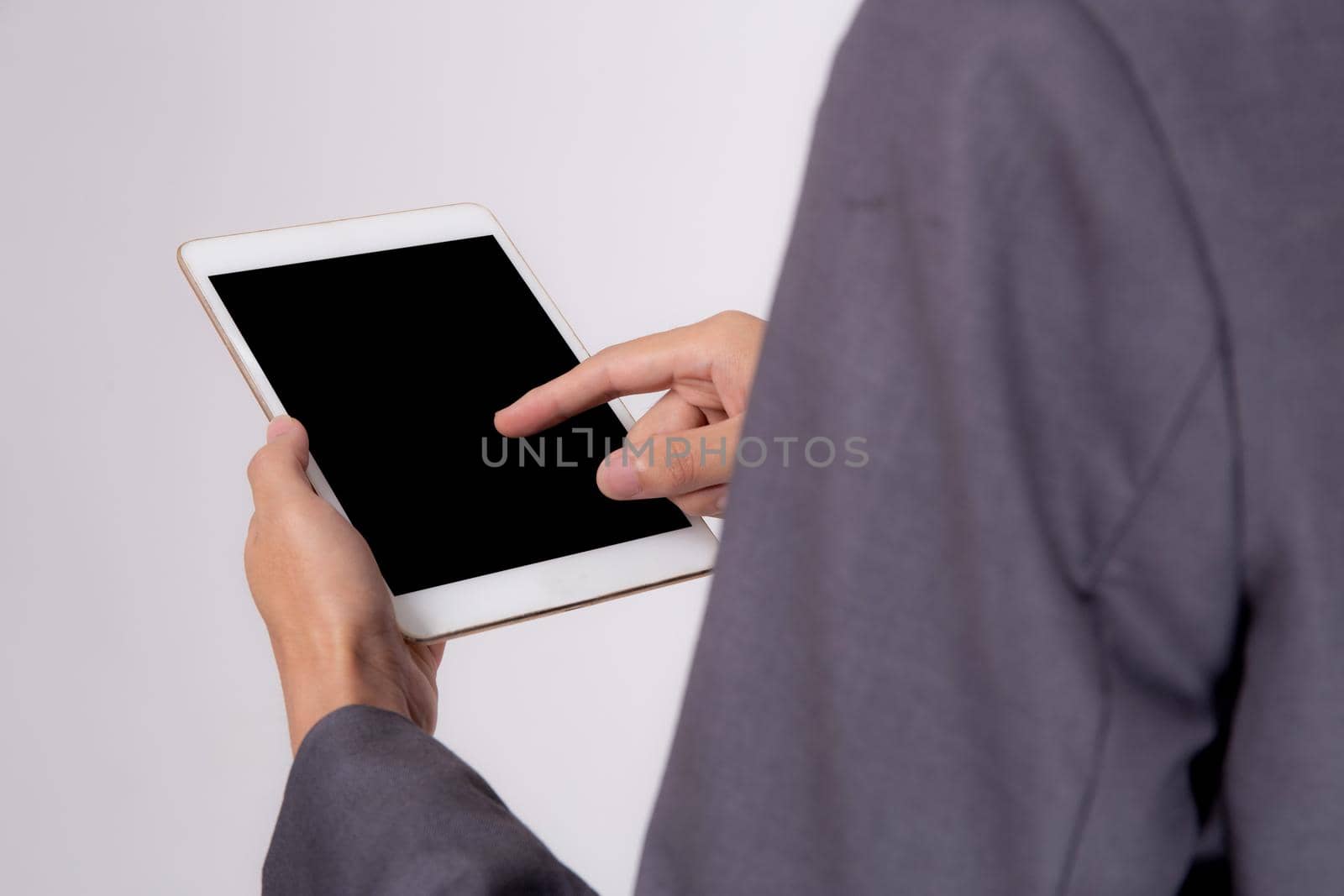 Closeup young asian business man showing and presenting tablet computer with blank screen with success isolated on white background, Hand of businessman using touchpad digital, communication concept. by nnudoo
