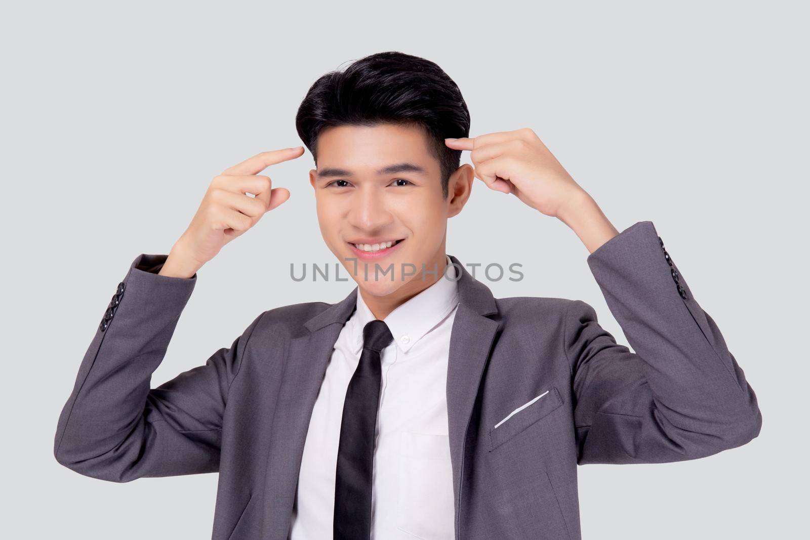 Portrait young asian business man in suit with smart thinking idea with intelligent isolated on white background, businessman standing and planning for success, manager or executive pointing head. by nnudoo