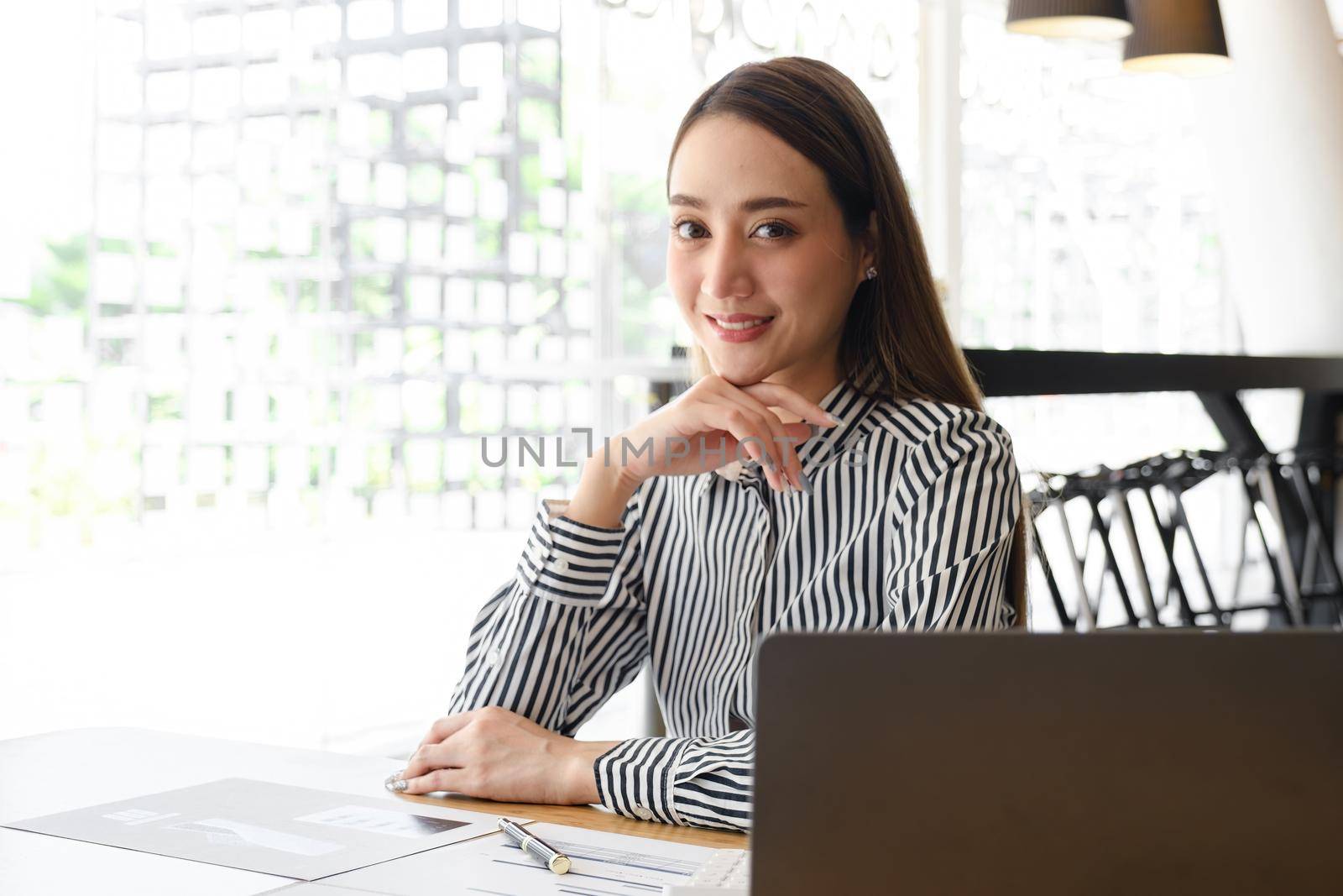 Asian Business Woman or Accountant with paperwork on desk, account, audit and saving concept. by itchaznong