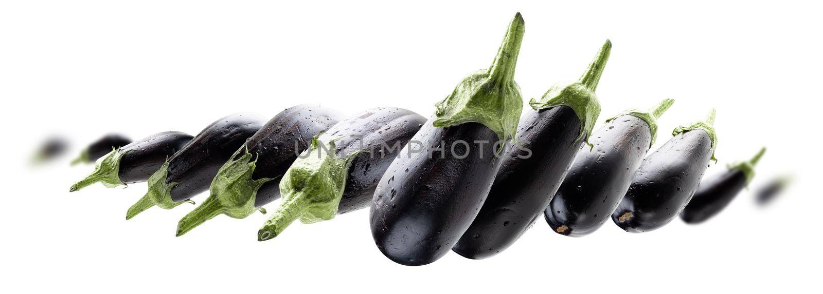 Ripe eggplants levitate on a white background.