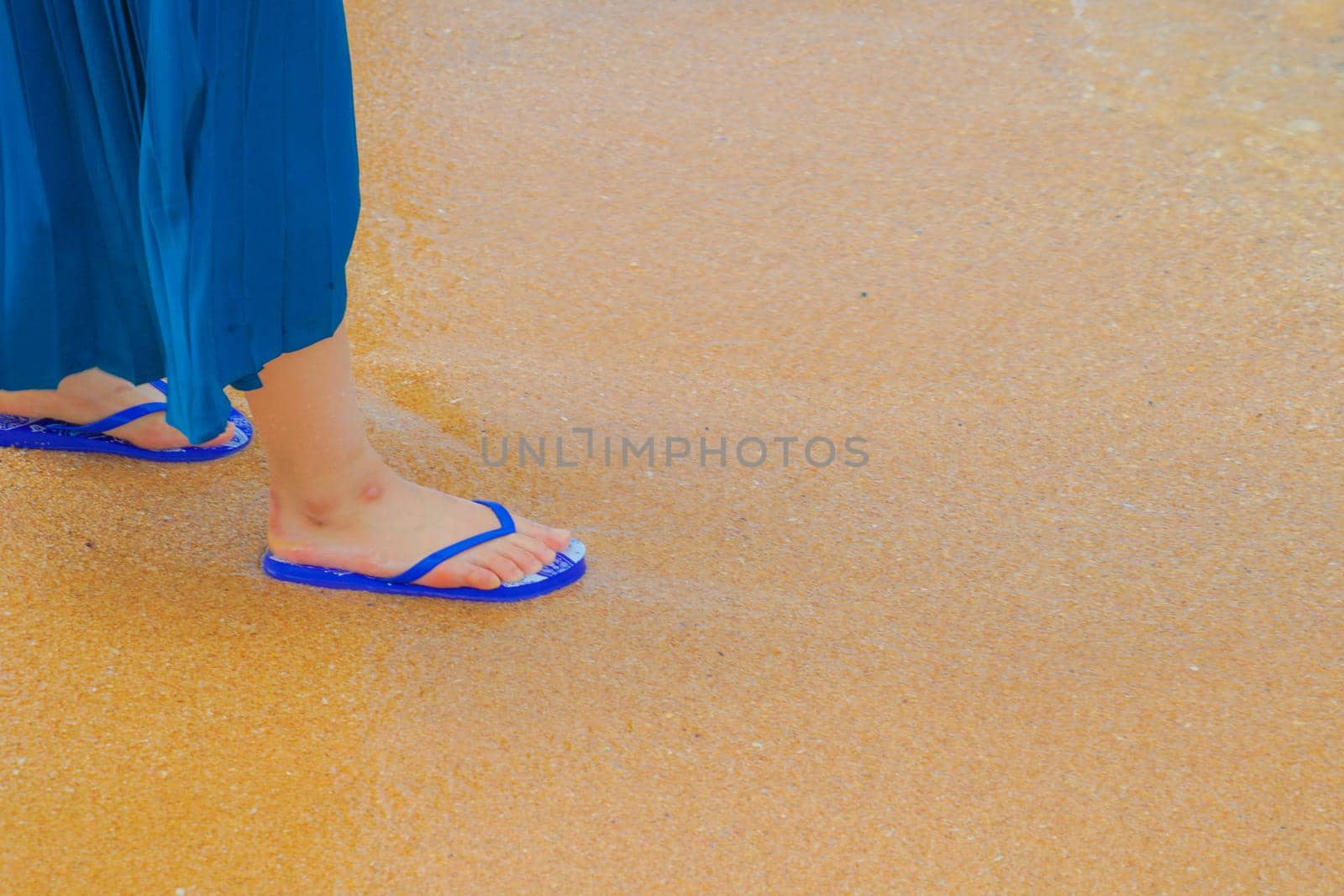 Woman foot walking in the sandy beach by kanzilyou