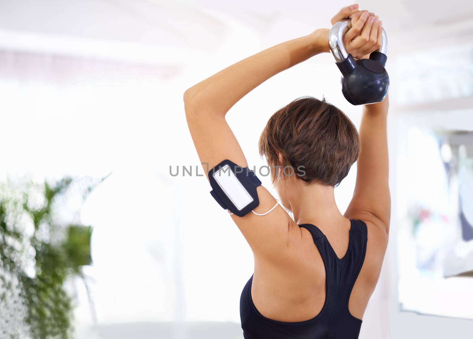 Shot of a woman working out with a dumbbells.