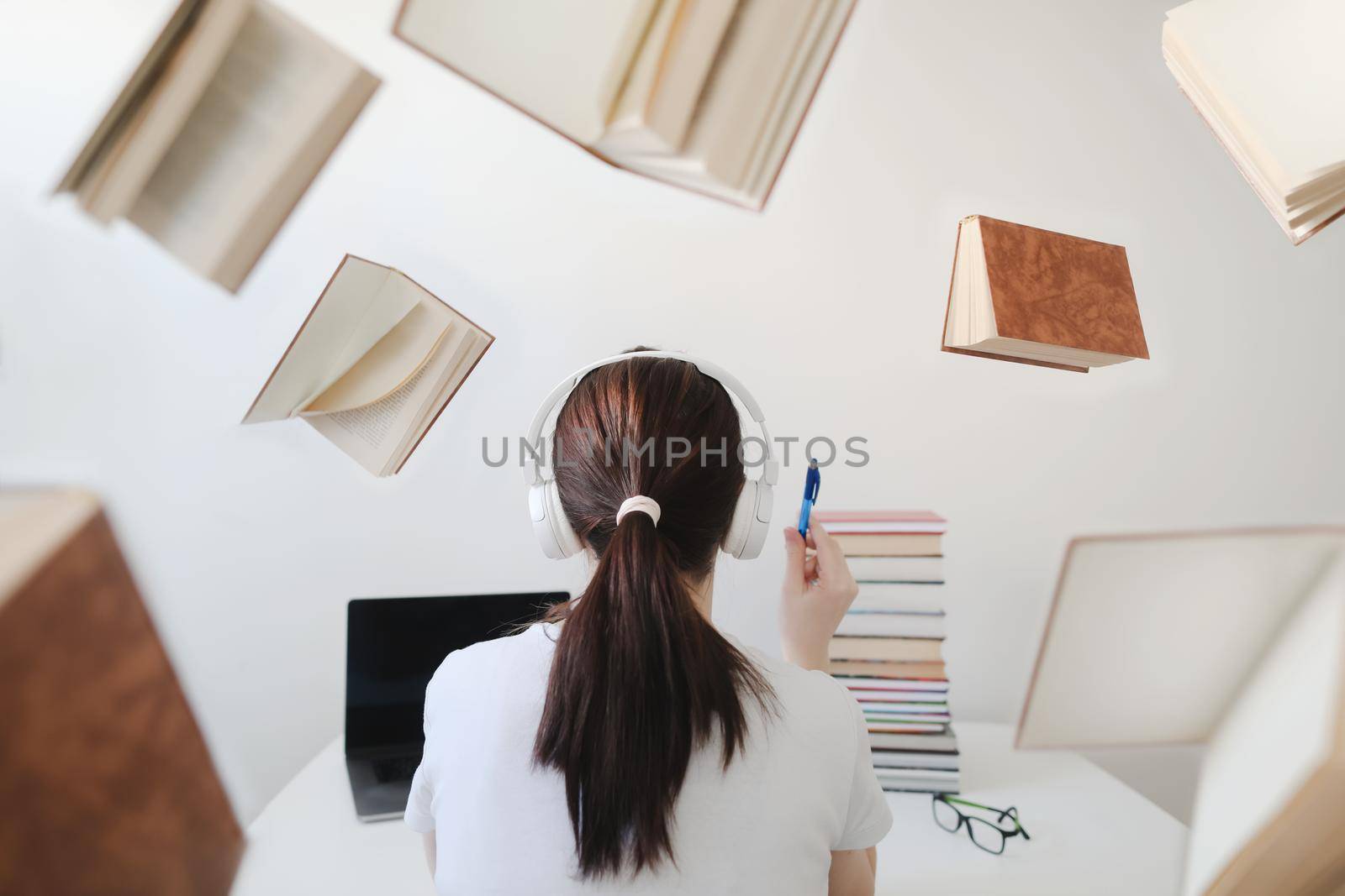 Portrait of a female student with books and glasses. Young female student reading books and preparing for exams. Creative photo
