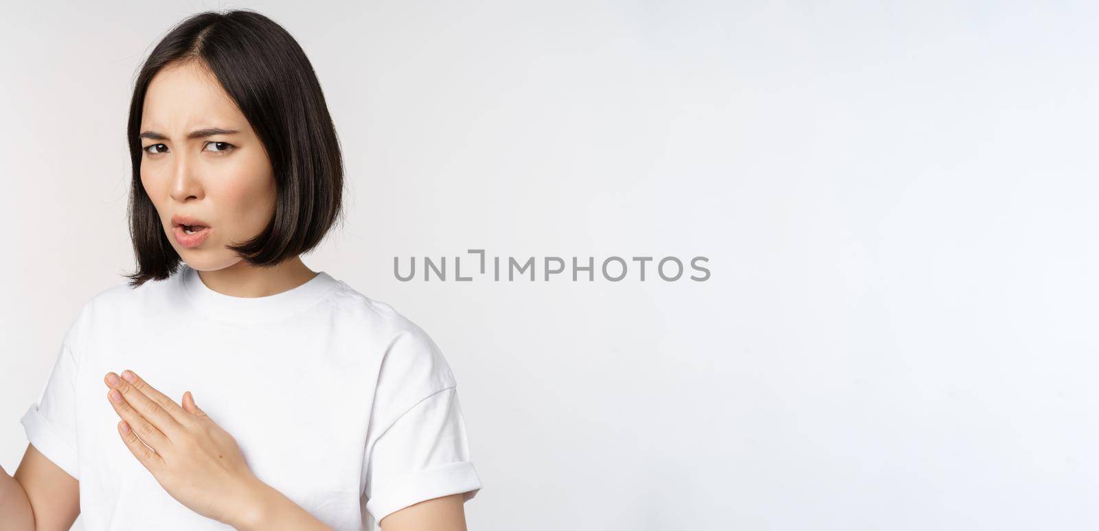 Image of sassy young asian woman standing in karate fighting pose, martial arts fighter, standing over white background.