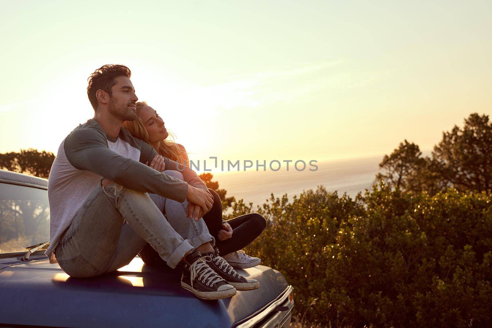Feels good to breakaway from the city. Shot of an affectionate young couple on a roadtrip. by YuriArcurs