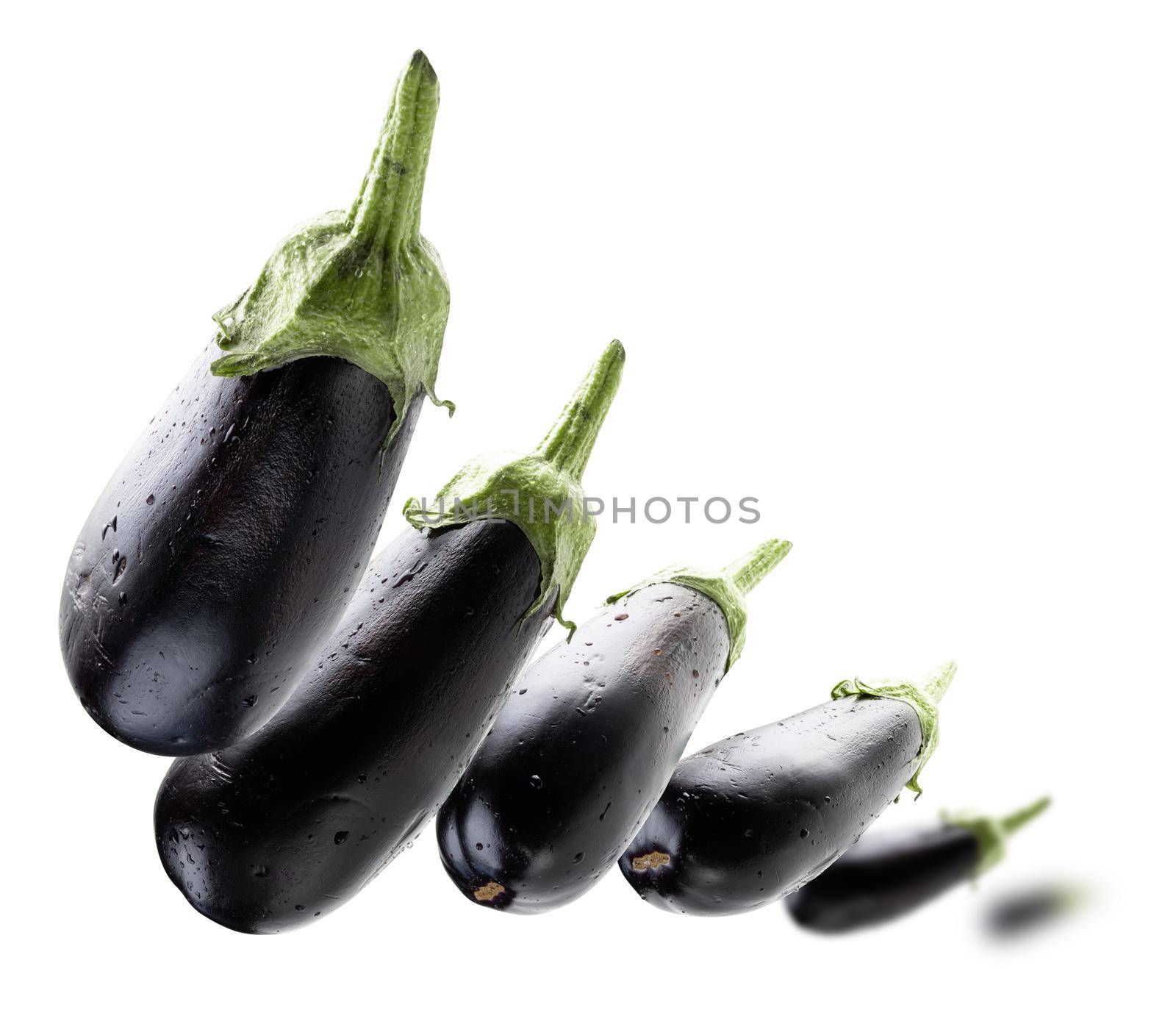 Ripe eggplants levitate on a white background.