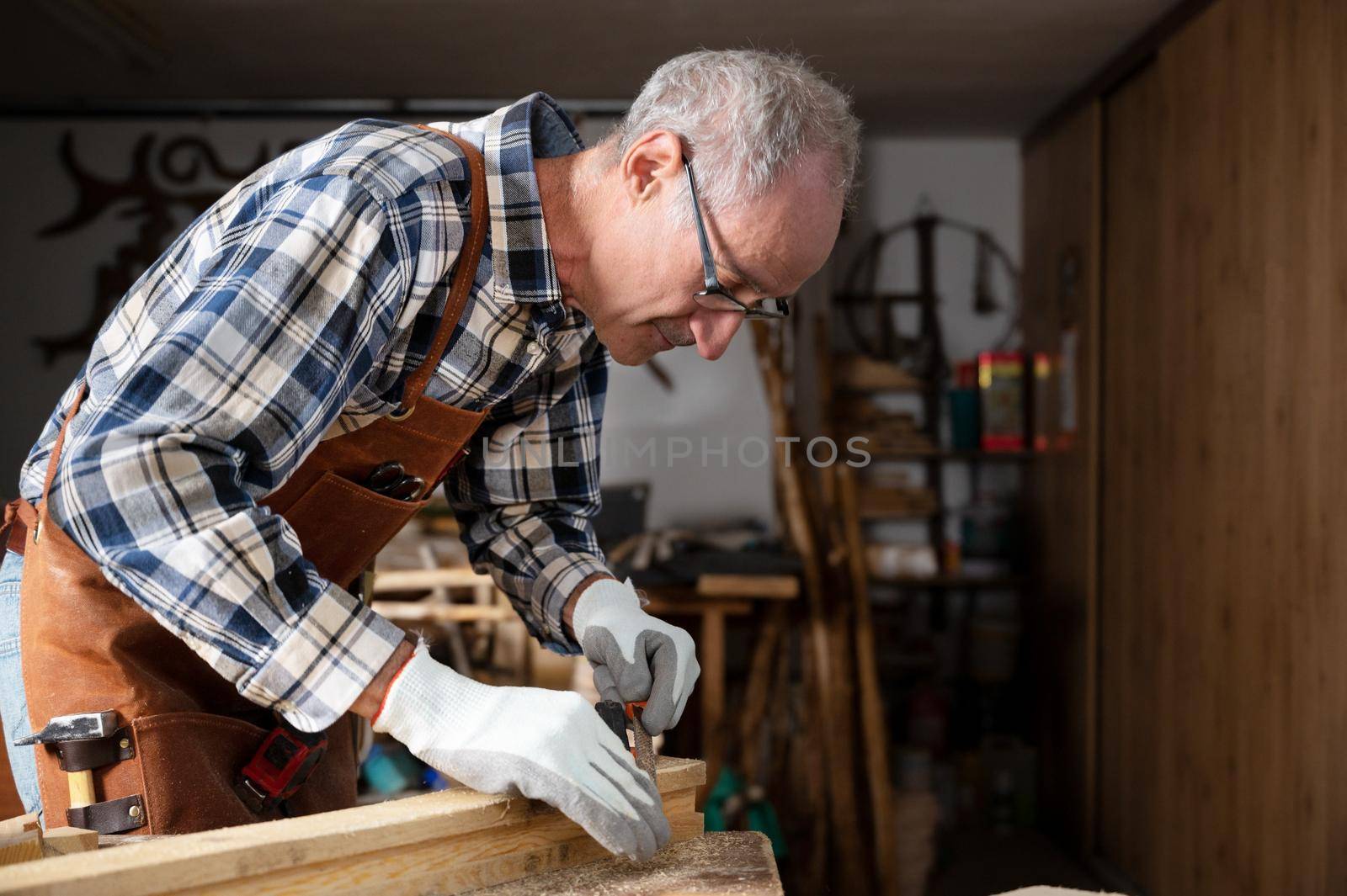Carpenter Working At Workshop by HERRAEZ