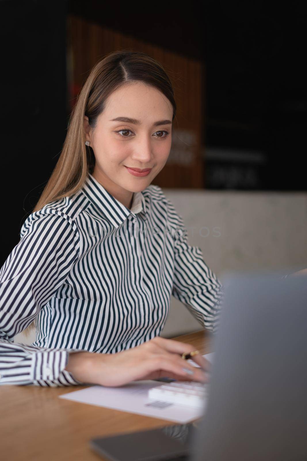 Business woman using laptop computer at office, account or saving money or insurance concept