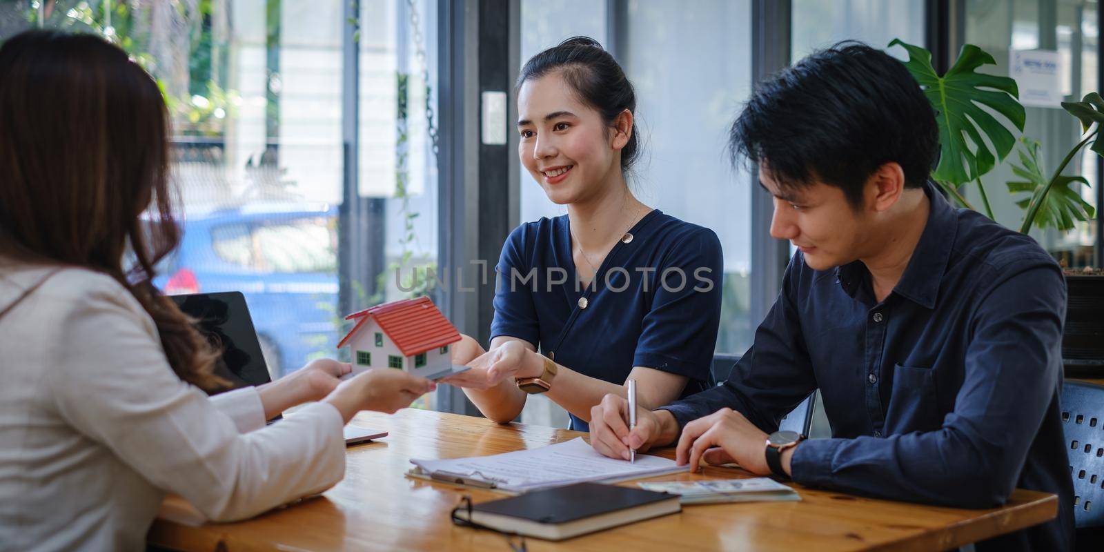 Young Couple decide before sign agreement contract and price while broker offer exclusive price. Real Estate concept. by itchaznong
