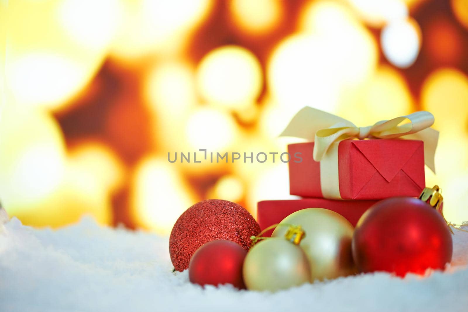 An arrangement of Christmas decorations against a background of lights.
