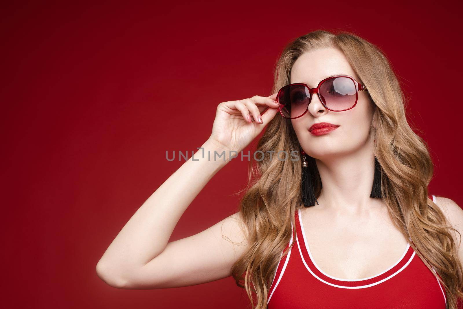 Beautiful female model posing on red background