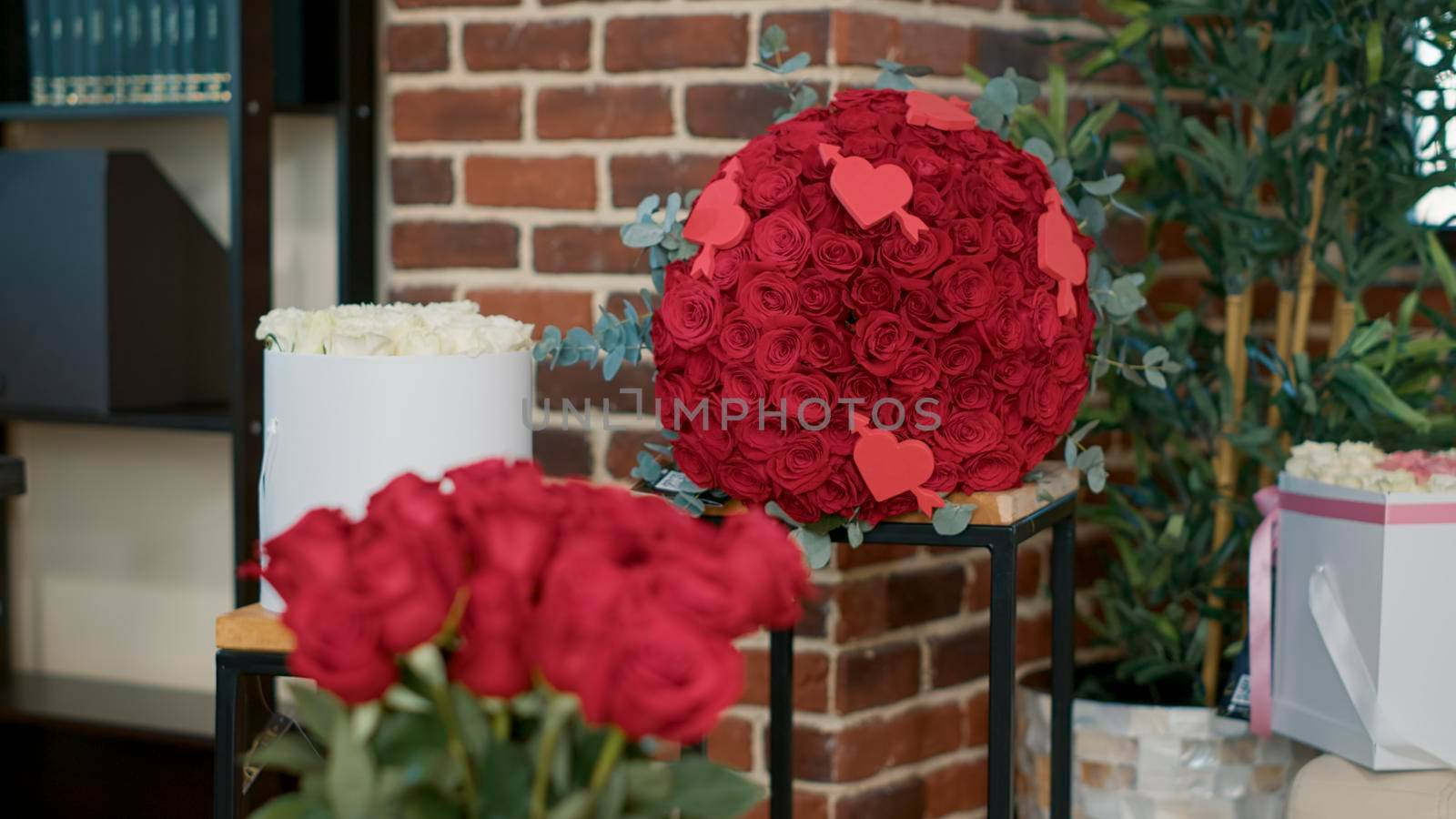 Closeup of bouquet with red roses standing in empty living room by DCStudio