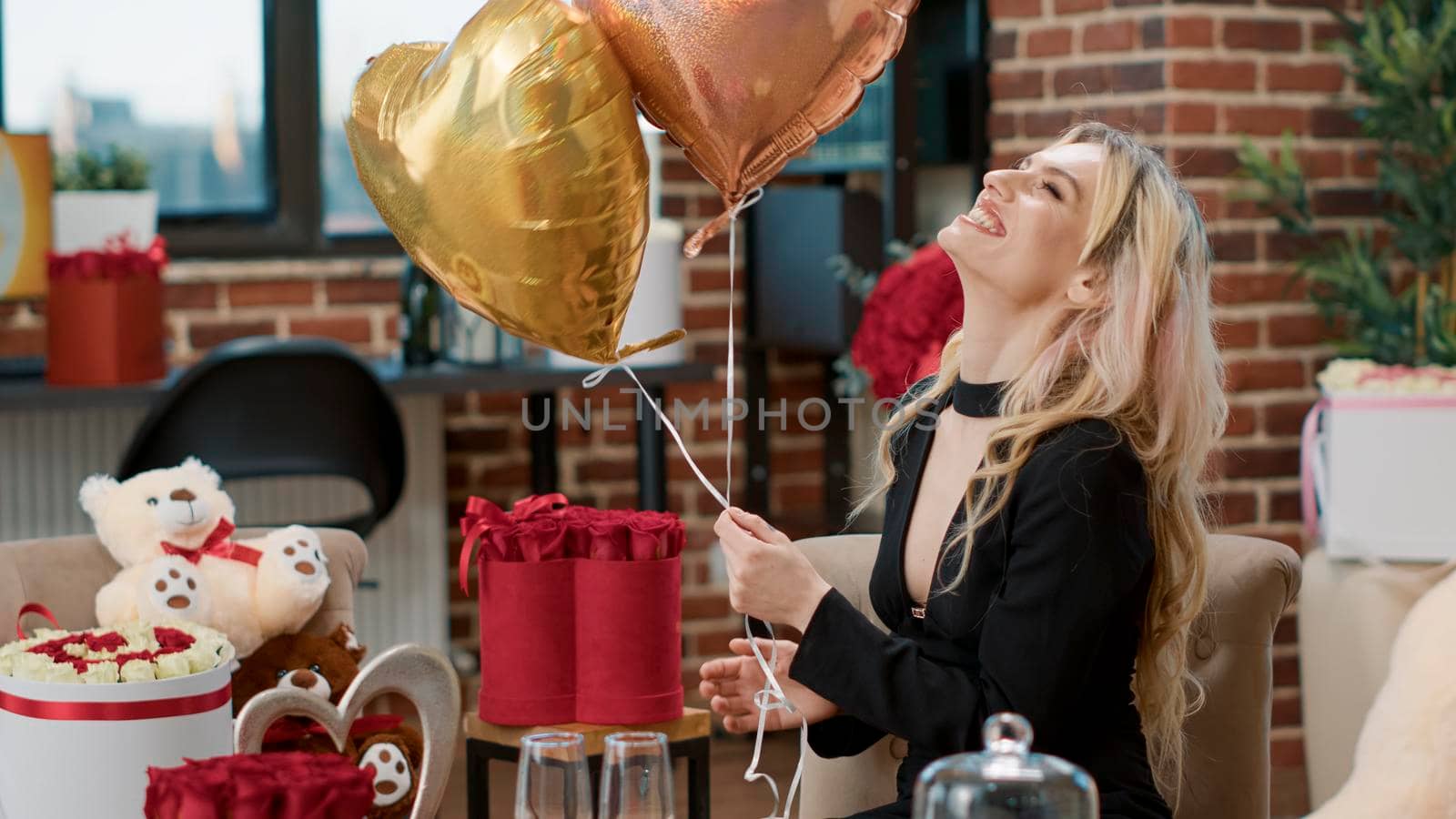 Attractive smiling woman enjoying romantic surprise with balloons by DCStudio