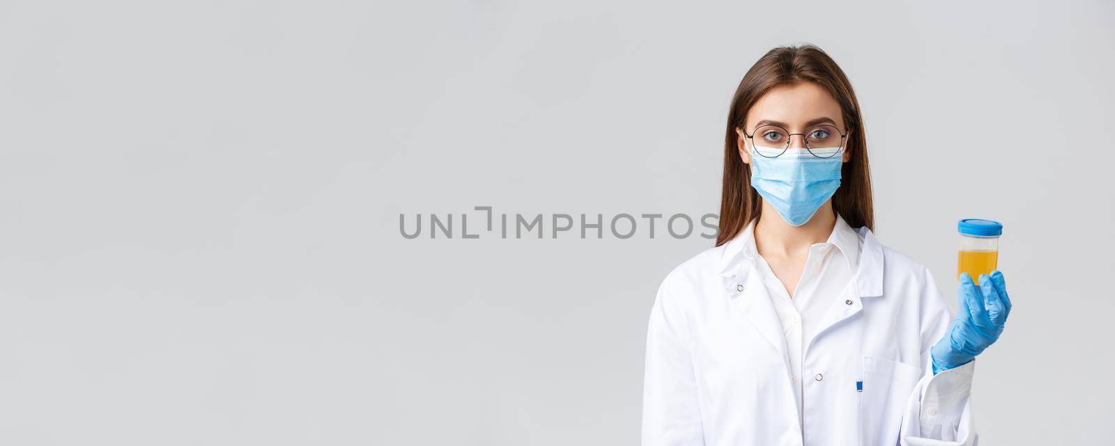 Covid-19, medical research, diagnosis, healthcare workers and quarantine concept. Doctor in clinic lab working with patient urine sample, making test find coronavirus infection, grey background by Benzoix