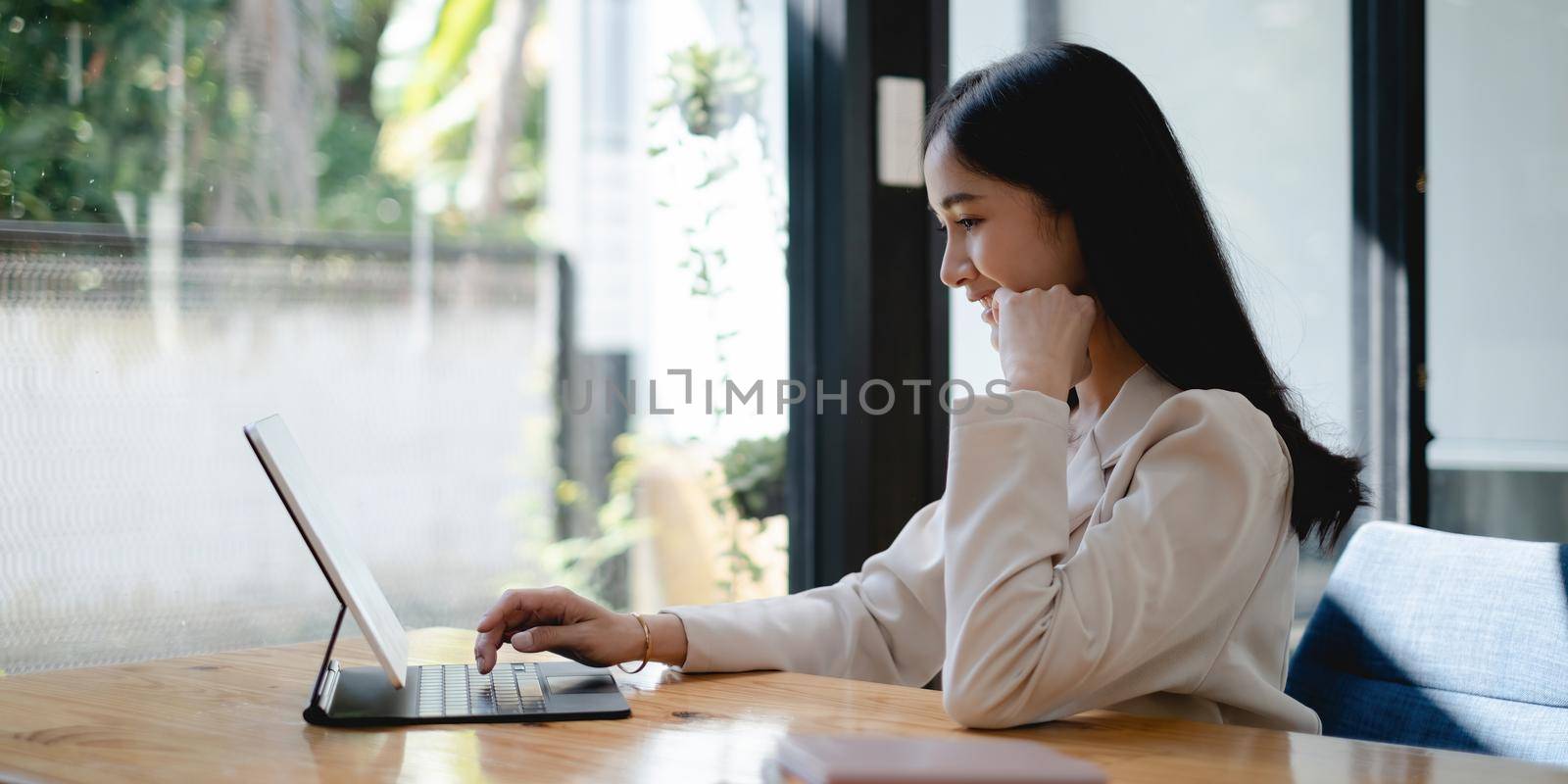 Business woman using digital tablet at office, account or saving money or insurance concept. by itchaznong