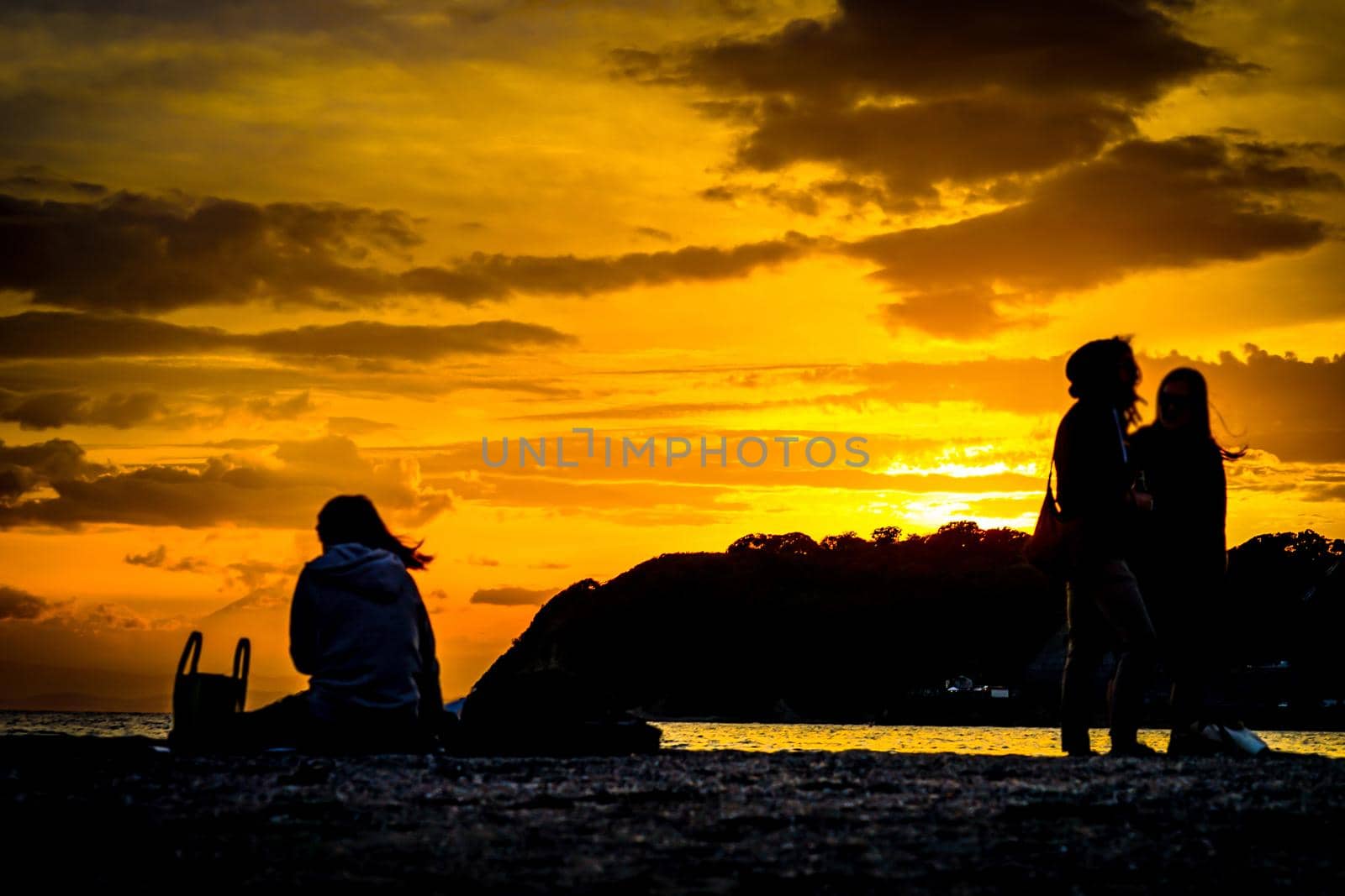 Sunset and people silhouettes of dumpling coast. Shooting Location: Tokyo metropolitan area