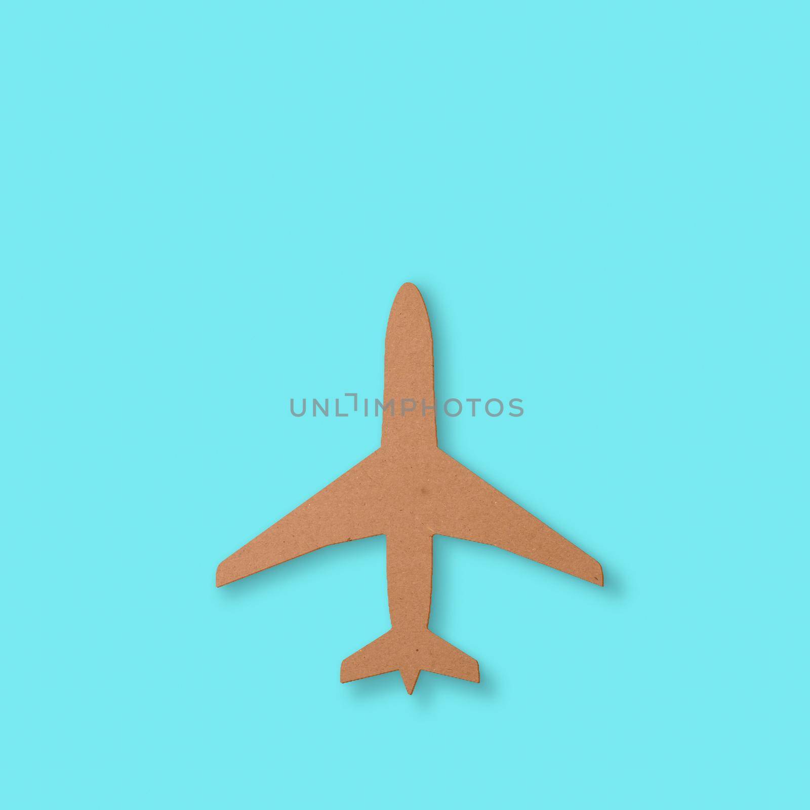 Cutout of an airplane over a blue background with copy space for travel themes