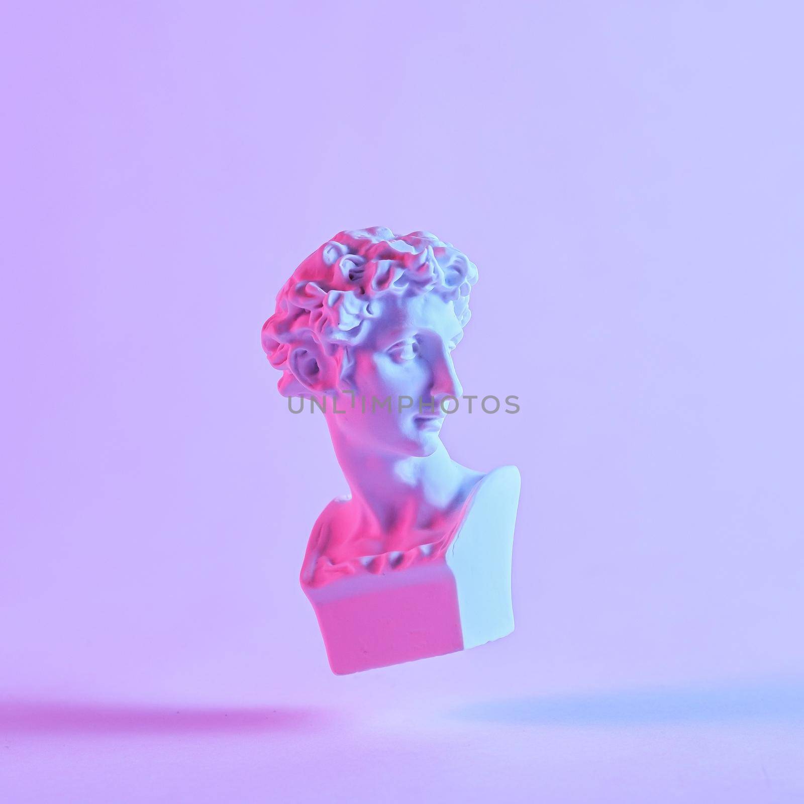 Monotone purple still life of a floating antique style Roman or Grecian bust with drop shadow in square format