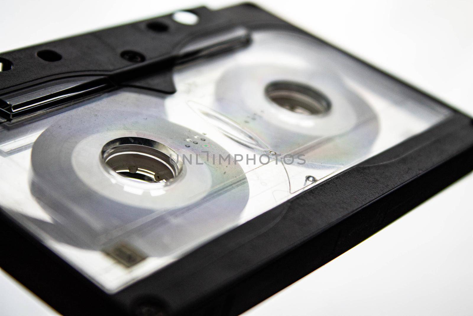 Disassembled audio cassette. Tangled cassette tape in knots. by Verrone