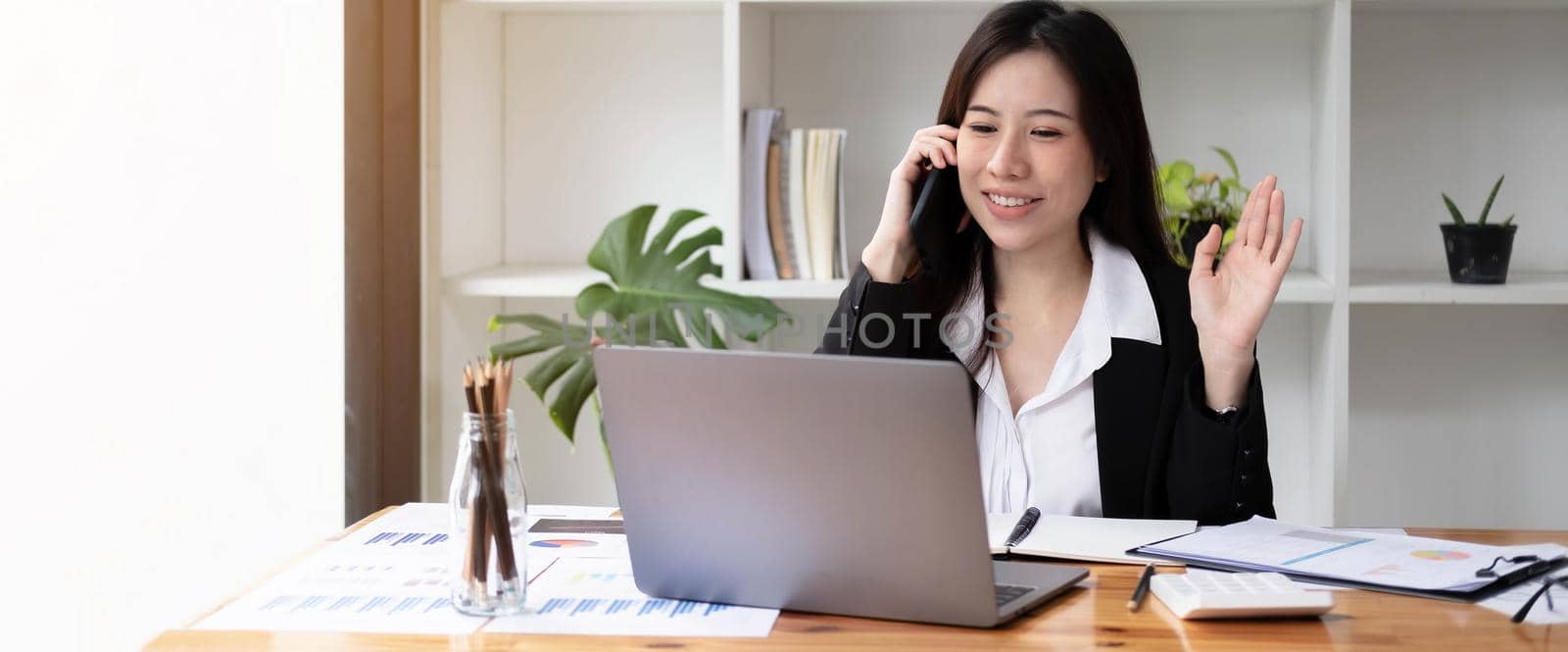 Protrait of Beautiful businesswoman sitting at desk and working with laptop computer..
