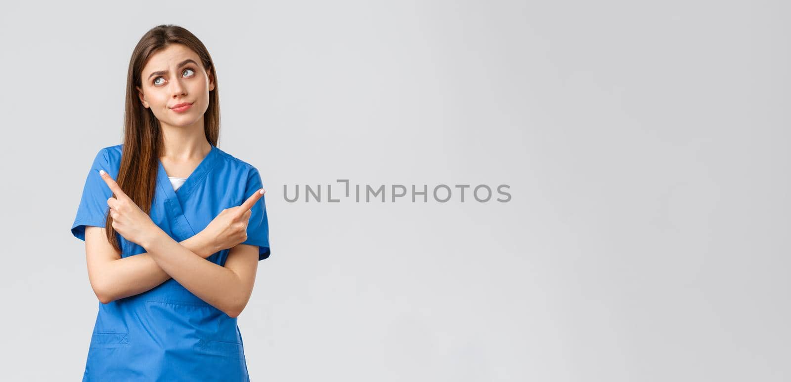 Healthcare workers, prevent virus, insurance and medicine concept. Nurse facing complicated choice. Doctor in blue scrubs, pointing sideways making tough decision, standing indecisive by Benzoix