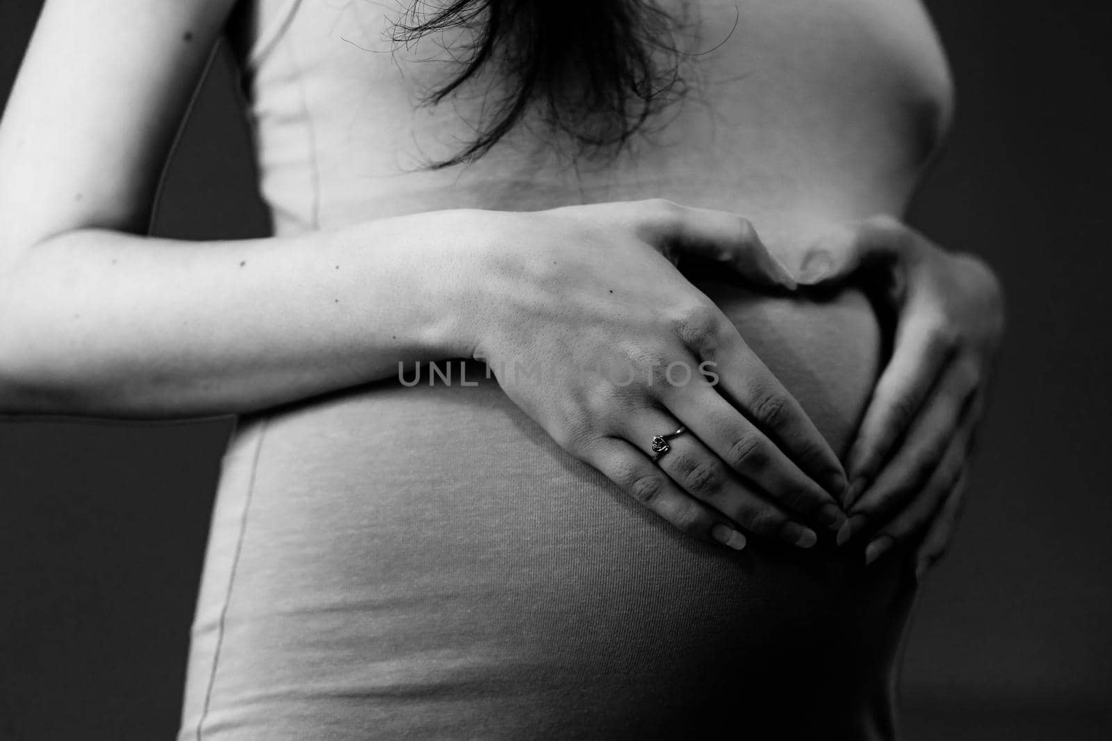 Pregnant woman making a heart on her belly