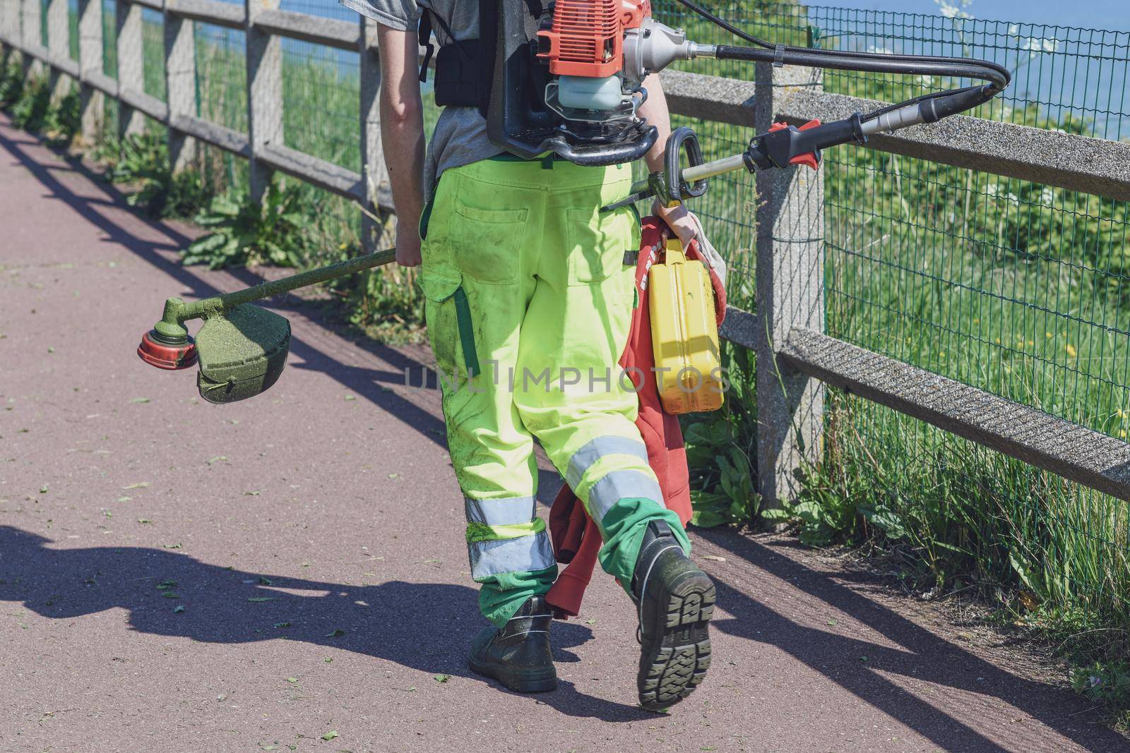 Lawn mower in a uniform with equipment