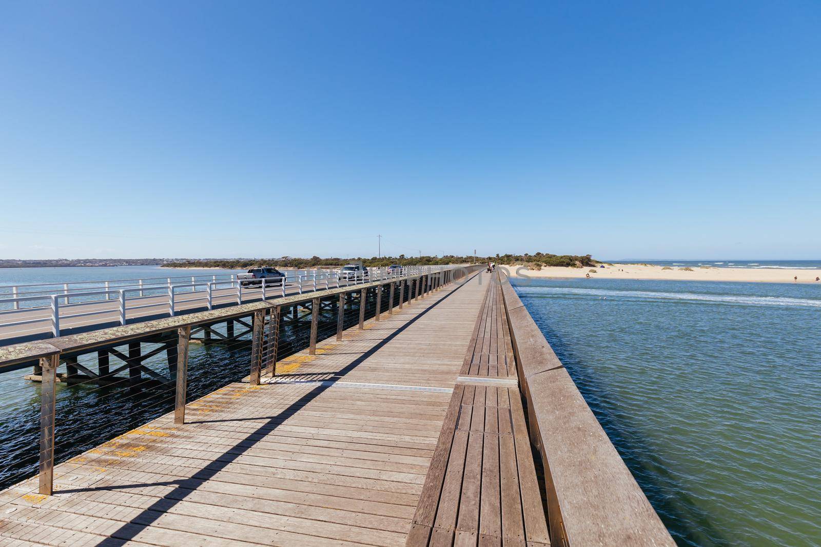 The idyllic Barwon River Beach and Barwon Heads Bridge on a hot summer's day in Barwon Heads, Victoria, Australia