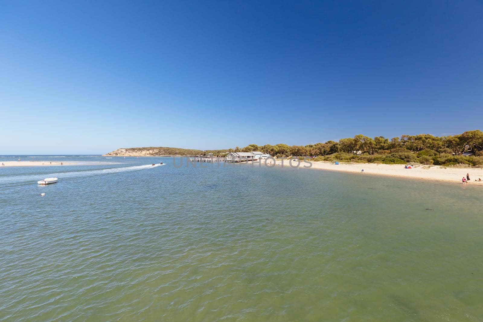 The idyllic Barwon River Beach and Barwon Heads Bridge on a hot summer's day in Barwon Heads, Victoria, Australia