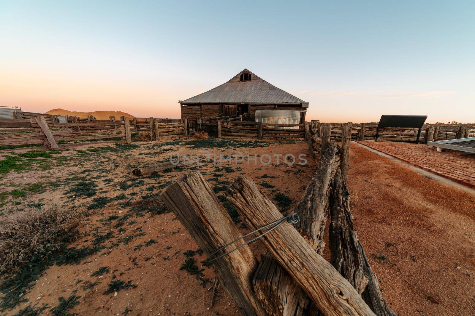 Old shearing sheds and dusty red dirt corals in outback Australia by lovleah