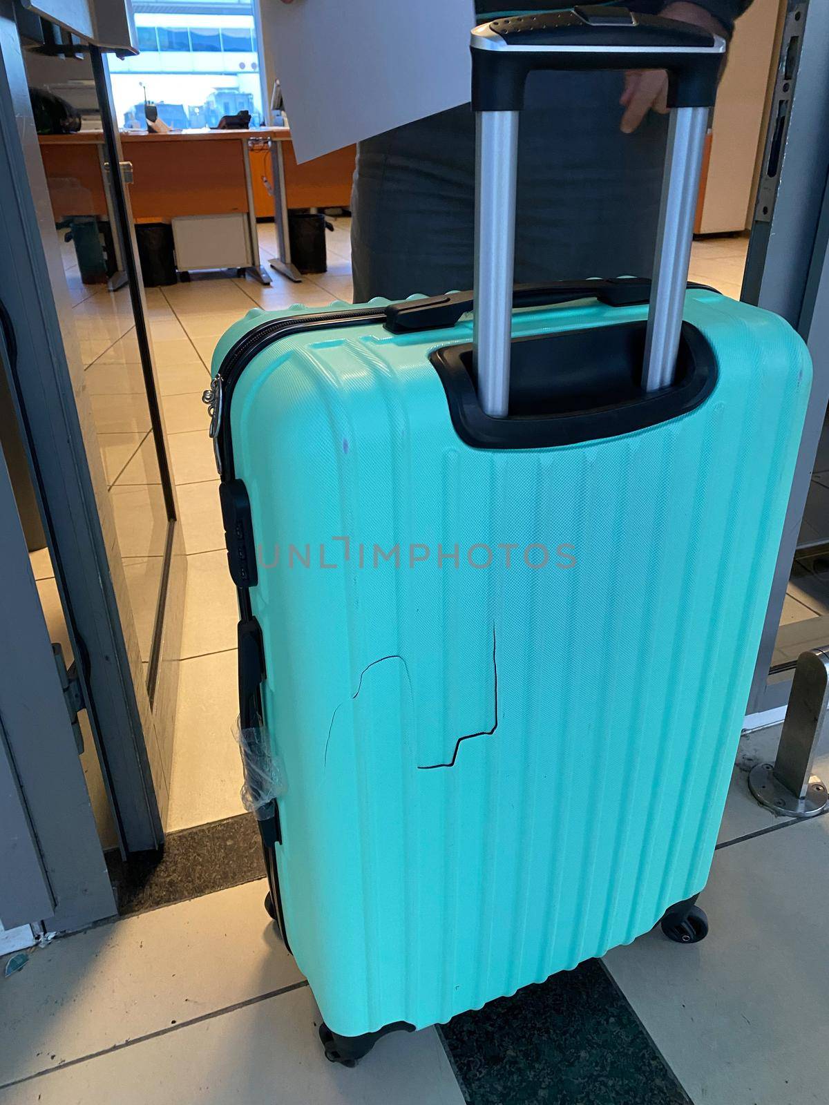Broken blue suitcase at the airport. Incident with luggage during the flight. by mrwed54
