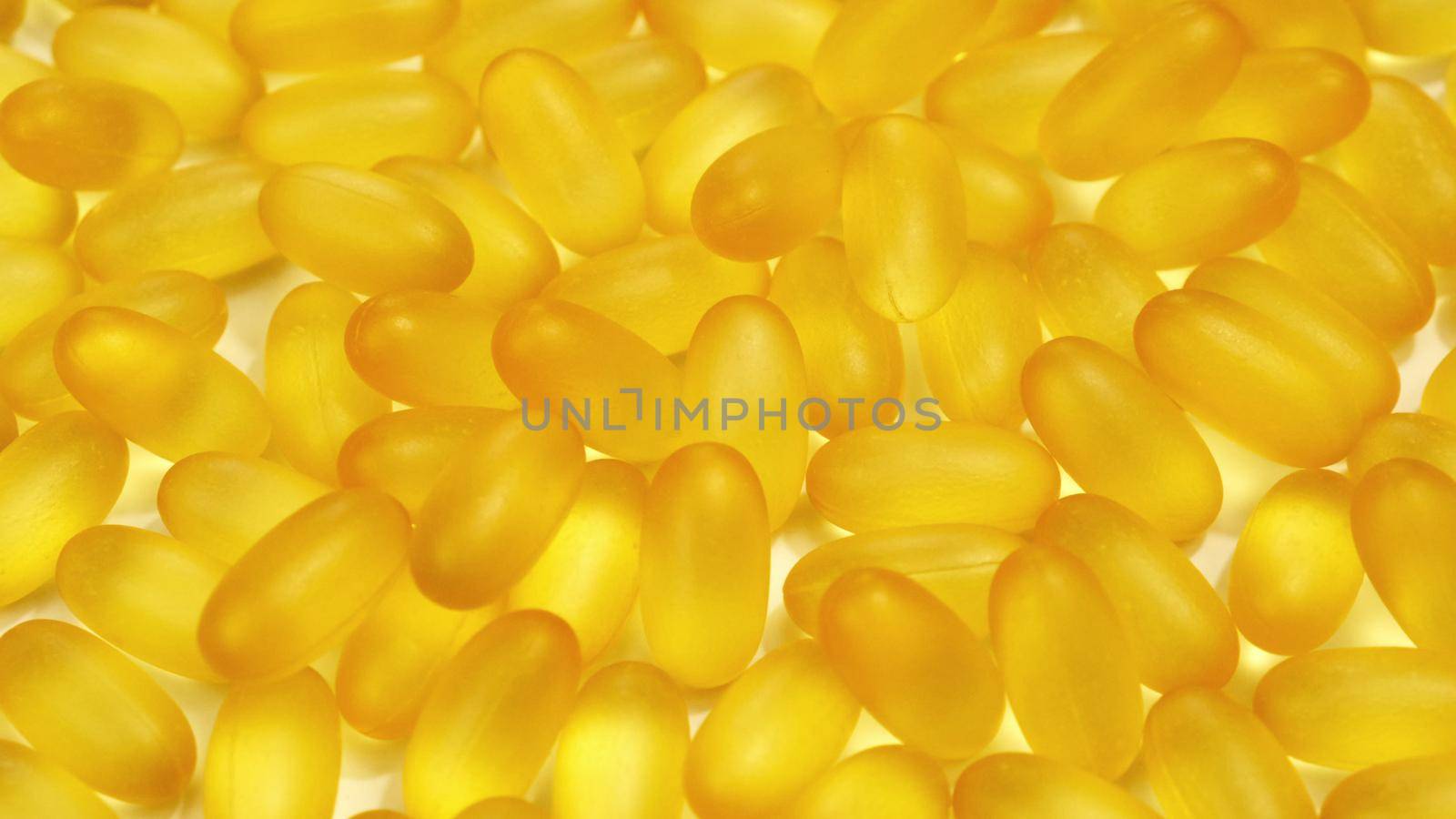 Organic supplements vitamins yellow capsules Omega 3 or D-3 pills, macro shot. Dietary supplement, close up.